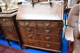 A Georgian Burr Walnut bureau having fitted interior beneath fall fap, with two over three drawer