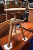 An adjustable pine stool