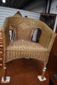 A modern woven wicker chair in a Llyod loom style.