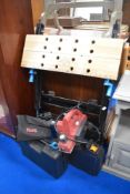 Three power tools with a fold away work mate.