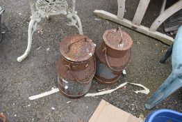Two vintage cast dairy milk churns.