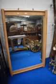 A large pine framed wall mirror.