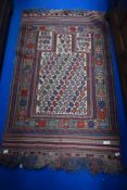 A Moroccan style prayer mat with vivid colour.