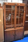 An early 20th century oak book case and cupboard with glazed doors.