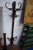 An early 20th century bent wood semi circle hat and caot stand.
