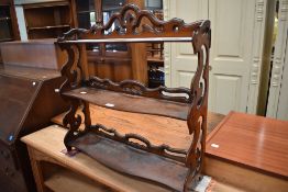 A Victorian Watnot Shelf with carved frame work.