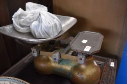 A set of vintage kitchen balance scales with weights.