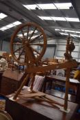 An early 20th century Beech wood framed spinning wheel.