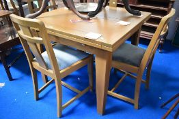 A 1950's utility style extending dining table and chairs