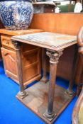 A Victorian mirror topped side table or plant stand with classical column supports.