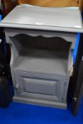 A modern painted pine bed side cabinet.