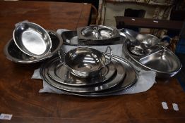 A selection of stainless steel serving plates and dishes.