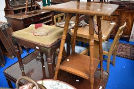 An Arts and Crafts style side table in golden oak with slight worm.
