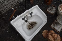 A vintage porcelain sink with taps.