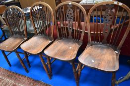 A set of four early 20th century wheel back and elm seat dining chairs.