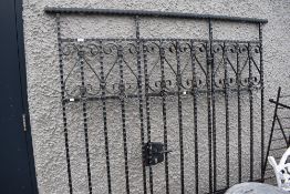 A wrought iron drive way gate and fence.