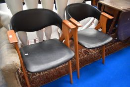 A pair of mid century Kai Kristiansen Compass style arm chairs.