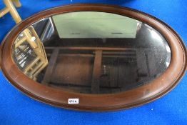 A mahogany frame oval wall mirror