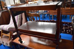 A vintage mahogany and rosewood effect metamorphic tea trolley