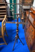 A Victorian adjustable music or book stand with turned mahogany frame.