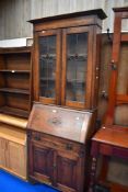 An early 20th century bureau book case with leaded light windows.