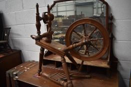 An early 20th century Beech wood framed spinning wheel.