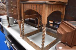 An Edwardian oak side table with barley twist legs.