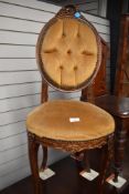 A vintage salon style bedroom chair with plush upholstery.