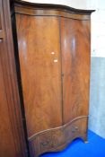 A Victorian serpentine fronted double wardrobe.