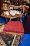A Victorian balloon back chair with carved legs and back.