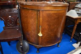 An Art Deco Demi Lune cabinet.