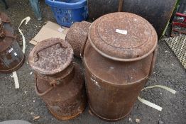 Two vintage cast dairy milk churns.