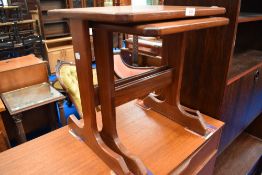 A mid century Teak nest of two G plan tables.