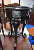 An Indian plant stand in the form of three elephant heads Ebonised.