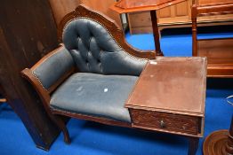 A vintage telephone table with blue button back leather.