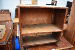 A vintage folk art style book shelf.