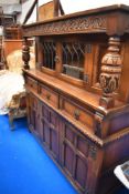 A vintage priory style side board with drawers and cupboard.