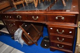A modern pedestal desk with Mahogany frame and skiver top.
