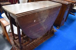 An early 20th century oak drop leaf table.