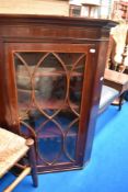A fine Victorian corner cupboard having astral glazed doors and velvet interior.