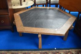 A mid century style hexagonal coffee table with slate effect top.