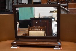 An early 20th century oak framed toilet mirror.