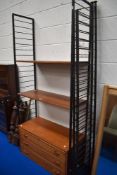A mid century metal Ladderax wall unit with four ladders, two shelves and a drawer unit.