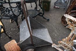A vintage galvanised feed barrow.