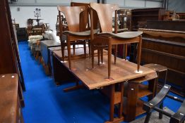 A mid century tile topped dinning table with four stylised 60's chairs.