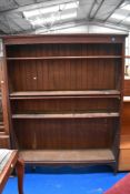 An arly 20th century adjustable book case with five shelves.