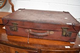 A vintage leather bound suitcase.