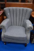 A modern arm chair in grey upholstery.