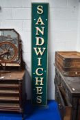 A vintage metal and plastic Sandwiches sign.