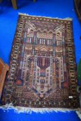A Persian style prayer mat with imagery of religious buildings.